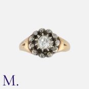 An Antique Old Cut Diamond Cluster Ring in yellow gold and silver, comprising a central old cut