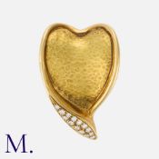 A Diamond Brooch in 18 carat yellow gold, designed as a stylised heart, with hammered texture,