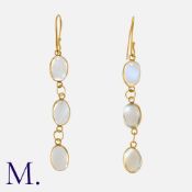 A Pair of Moonstone Drop Earrings in yellow gold, comprising a trio of articulated cabochon