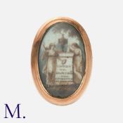 A Georgian Memorial Ring in rose gold with a glazed miniature portrait to the front and