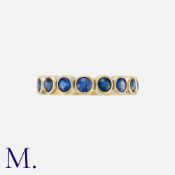 ALAN MARTIN GARD, A Sapphire Ring in 18 carat yellow gold, set with eight round cut sapphires.