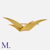 HERMES. A Gold Abstract Brooch in 18K yellow gold with an overlapping winged design - one smooth and