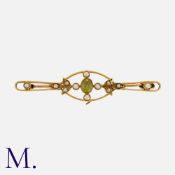 A Peridot and Pearl Brooch in 15 carat yellow gold, set with an oval cut peridot accented by pearls.