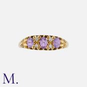 An Antique Pink Sapphire and Diamond Ring in 18K yellow gold, set with three oval cut pink sapphires