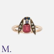 An Antique Paste Ring in 9 carat yellow gold and silver, designed as an insect, set with a red paste