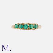 An Antique Emerald 5-Stone Ring in yellow gold, set with five round cut emeralds to a carved head.