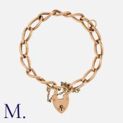 An Antique Curb Bracelet in 9K rose gold, with elongated curb links secured with a padlock clasp.