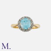A Zircon and Diamond Ring in 18K yellow gold, set with a round cut blue zircon measuring 6.7mm in