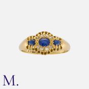 A Sapphire and Diamond Ring in 18 carat yellow gold, set with three cushion cut sapphires, the
