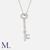 TIFFANY & CO. A Diamond Key Pendant Necklace in platinum, the key pendant set with round cut