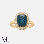 A Spinel and Diamond Cluster Ring in yellow gold, set with a cushion cut spinel of approximately 4.