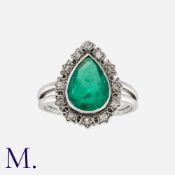 A Colombian Emerald and Diamond Ring in white gold, set with a pear shaped emerald of