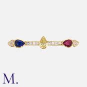 BULGARI, A Coloured Diamond, Sapphire and Ruby Brooch in yellow gold, set with a pear shaped