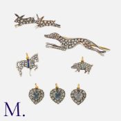 A Collection of Charms and Brooches, to include; three moonstone and diamond heart charms, a ruby