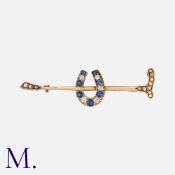 An Antique Sapphire and Diamond Horseshoe and Crop Brooch in yellow gold, set with old cut