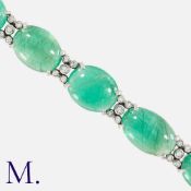 A Cabochon Emerald and Diamond Bracelet in white gold set with ten oval cabochon emeralds with round