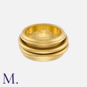 PIAGET. A Spinning Ring in 18K yellow gold, with two thinner bands which spin around the centre of