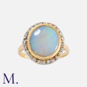 An Antique Opal and Diamond Cluster Ring in 18K yellow gold set with a large oval opal (approx. 13.