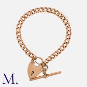 A Gold Curb Bracelet in 9K rose gold with padlock clasp and T-bar. Padlock stamped 9ct and links