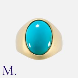 A Turquoise Ring in yellow gold, set with an oval cabochon turquoise. Unmarked; tests indicate