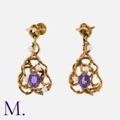 A Pair of Amethyst and Pearl Modernist Earrings of srolling, abstract design, each set with an