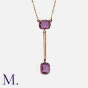 An Antique Amethyst Pendant in 9K rose gold, set with two cushion cut amethysts with bar between