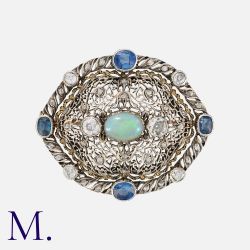 BUCCELLATI. An Opal, Sapphire and Diamond Brooch in yellow gold and silver, set to the centre with a