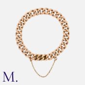 A Gold Curb Bracelet in 9K rose gold, with integrated fastening and safety chain. Size: 21cm Weight: