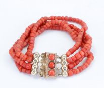 A four-strand blood coral bracelet with a 14kt yellow gold clasp (center bead on clasp not coral), t