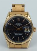 A Rolex Oyster Perpetual Date, with a gold-plated bracelet. The caseback has been replaced and engra