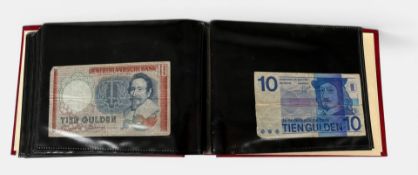 An album of various Guilder banknotes, including 100 Guilder and 250 Guilder.