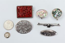 Lot of various silver jewelry, including brooches, together with two pill boxes and two coins. Total