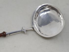A 19th century Scottish silver Ladle with oval bowl, scroll lower handle and finely turned wooden