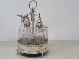 A George III silver Cruet Stand of pierced circular form with central handle and turned wooden base,