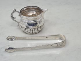 A Victorian silver circular Cream Jug, semi-fluted with scroll handle, London 1886, and a pair of