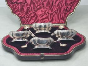 A Set of four Victorian silver shaped oval Salts with engraved friezes, and four Spoons,