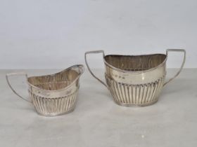 A Victorian silver two handled oval Sugar Bowl and Milk Jug, semi-fluted, Birmingham 1894, 156gms