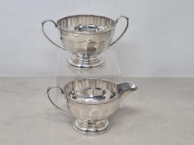 A George V silver two handled Sugar Bowl and Jug of panelled circular form, Birmingham 1929, 310gms