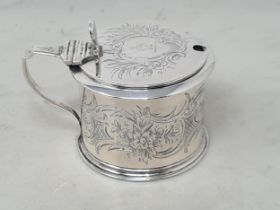 A Victorian silver Drum Mustard Pot with floral and scroll engraving, with crest, London 1848,