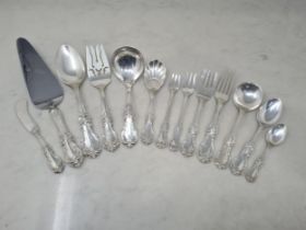 A sterling silver Canteen of Cutlery by Reed & Barton with floral and scroll pattern stems, viz: 8