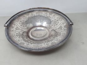 A Victorian silver circular cake Basket with floral and leafage scroll engraving, beaded rim,