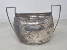 A George III silver two handled oval Sugar Bowl with engraved friezes and vacant cartouches,