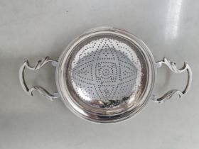A George II silver two handled lemon Squeezer with shaped handles, London probably 1749, maker: E.