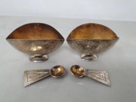 A pair of Elizabeth II silver oval Designer Salts with hammered design on pedestal bases, with