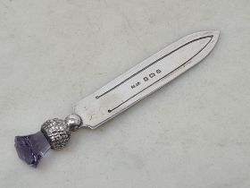 A George V silver Book mark in the form of a dagger with thistle finial set amethyst type finial,