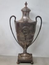 A George III silver Tea Urn of small proportions semi-fluted, engraved crest, embossed swags, beaded