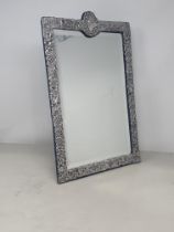 An Edward VII silver framed large Easel Mirror with bird, floral and leafage scroll embossing,