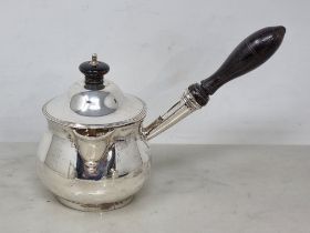 A George III silver Brandy Saucepan and Cover of bellied form with turned ebonised handle, London