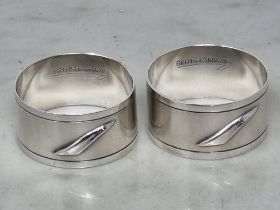 A pair of Elizabeth II silver British Airways Concorde circular Napkin Rings, Sheffield 1992, plus a