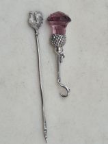 A silver Button Hook with thistle finial set amethyst glass, and a George V silver Cocktail Stick